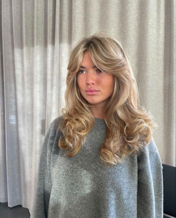 1970s inspired blowout layers curtain bangs