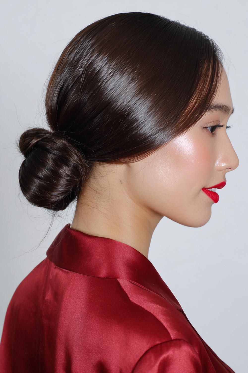 18. Best Hairstyles for 2026: Low Bun Hairstyle with Center Part and Glossy Finish