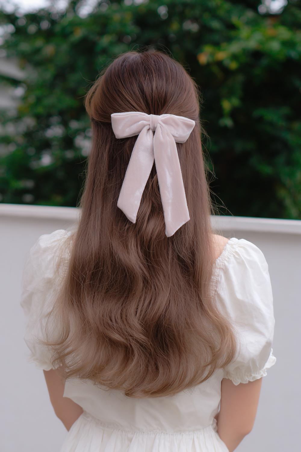 20. Best Hairstyles for 2026: Half-Up Hairstyle with Velvet Bow and Soft Waves