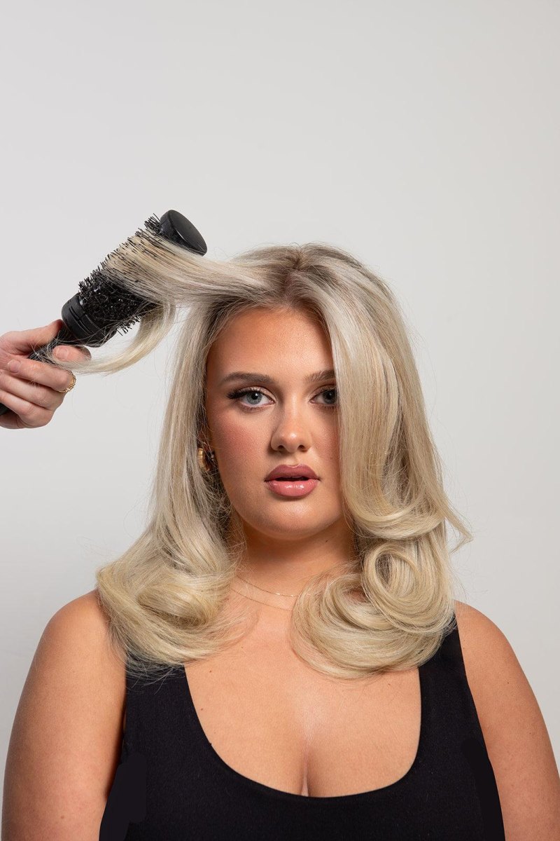 Blonde woman with platinum 90s blowout hair volume
