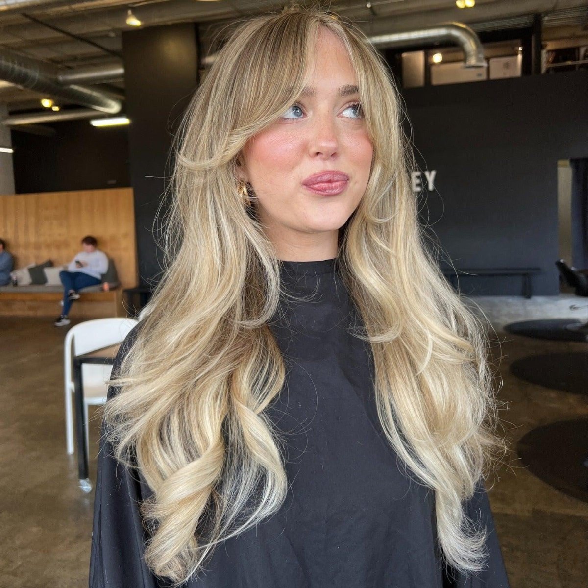 Blonde waves with curtain bangs