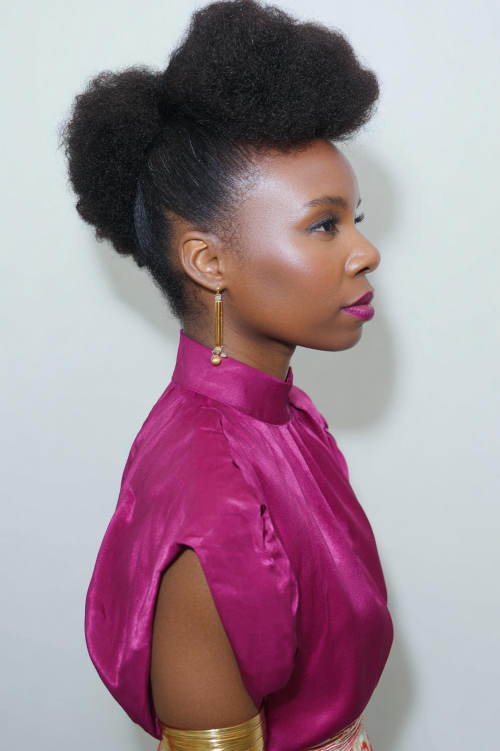 17. Coily Puff Hairstyle with Soft Brush Sides and Gold Cuff Accent