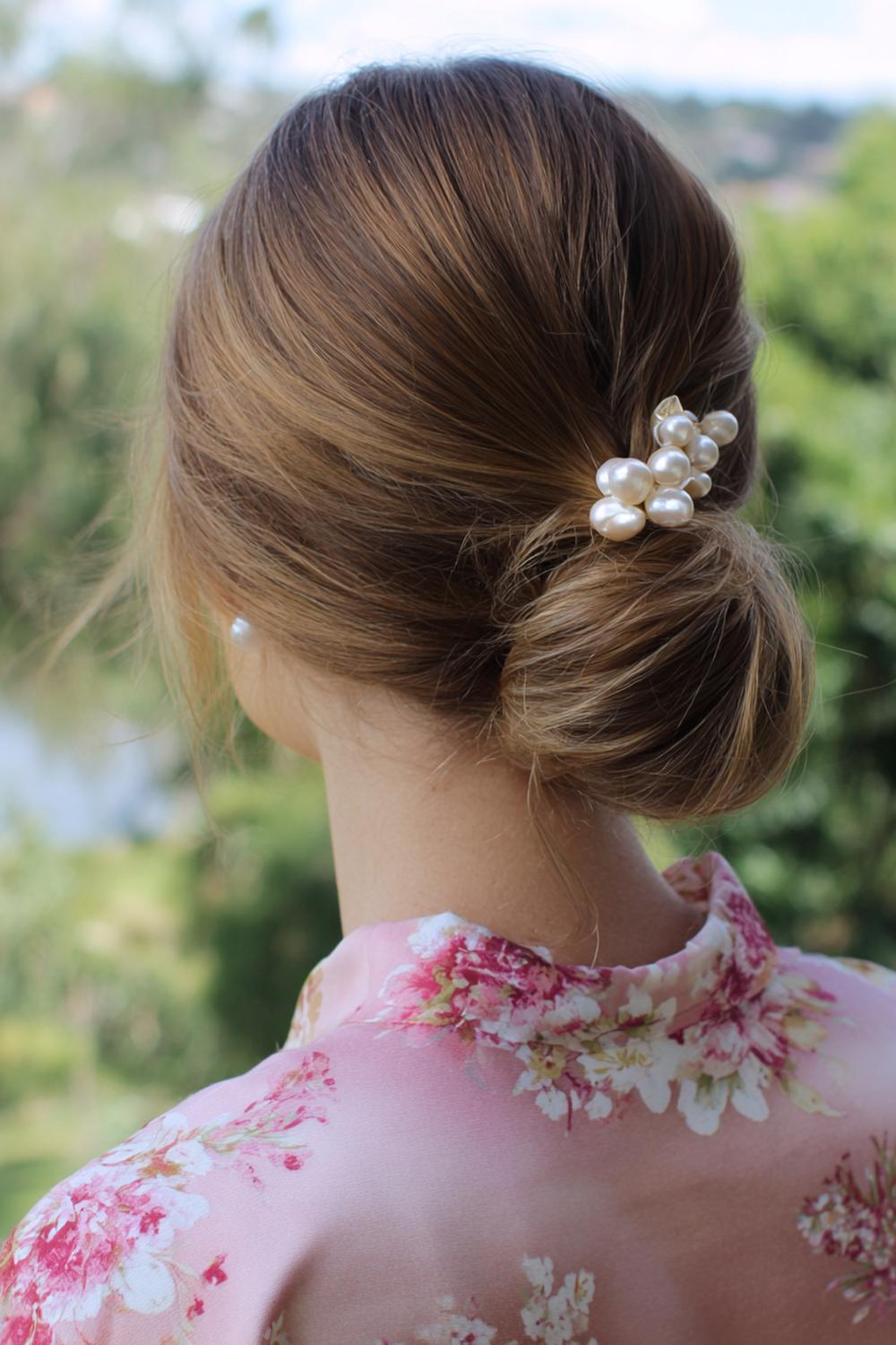 18. Low Chignon Hairstyle with Side Part and Pearl Pins