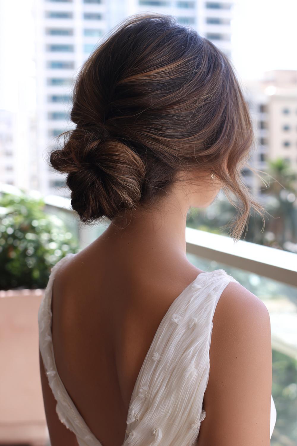 5. Textured Low Bun Hairstyle with Twisted Sides and Matte Finish