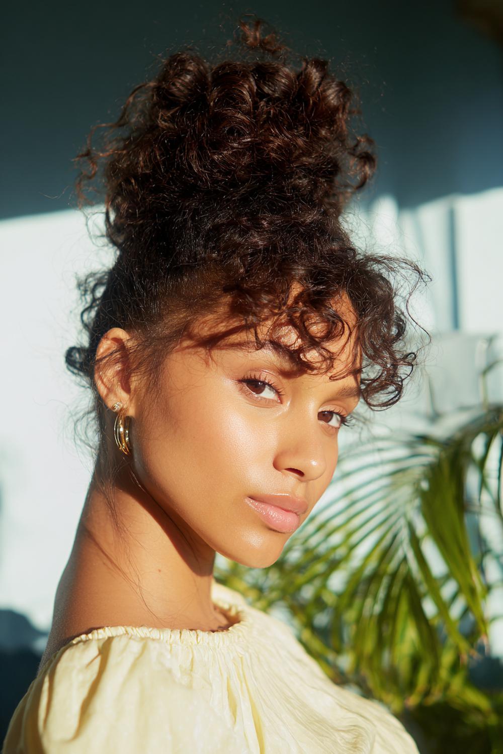 21. Everyday Hairstyles for Women: Curly Pineapple Updo with Defined Baby Hairs