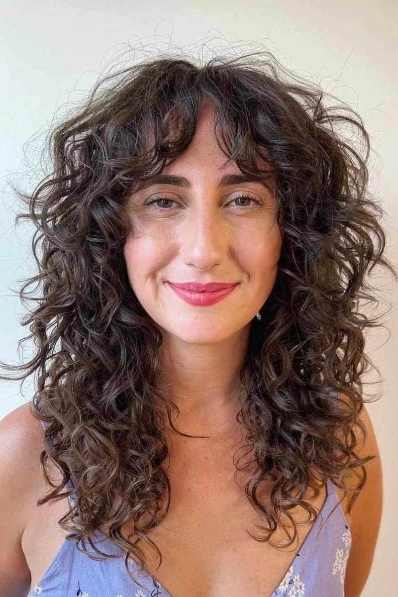 Curly hair curtain bangs style