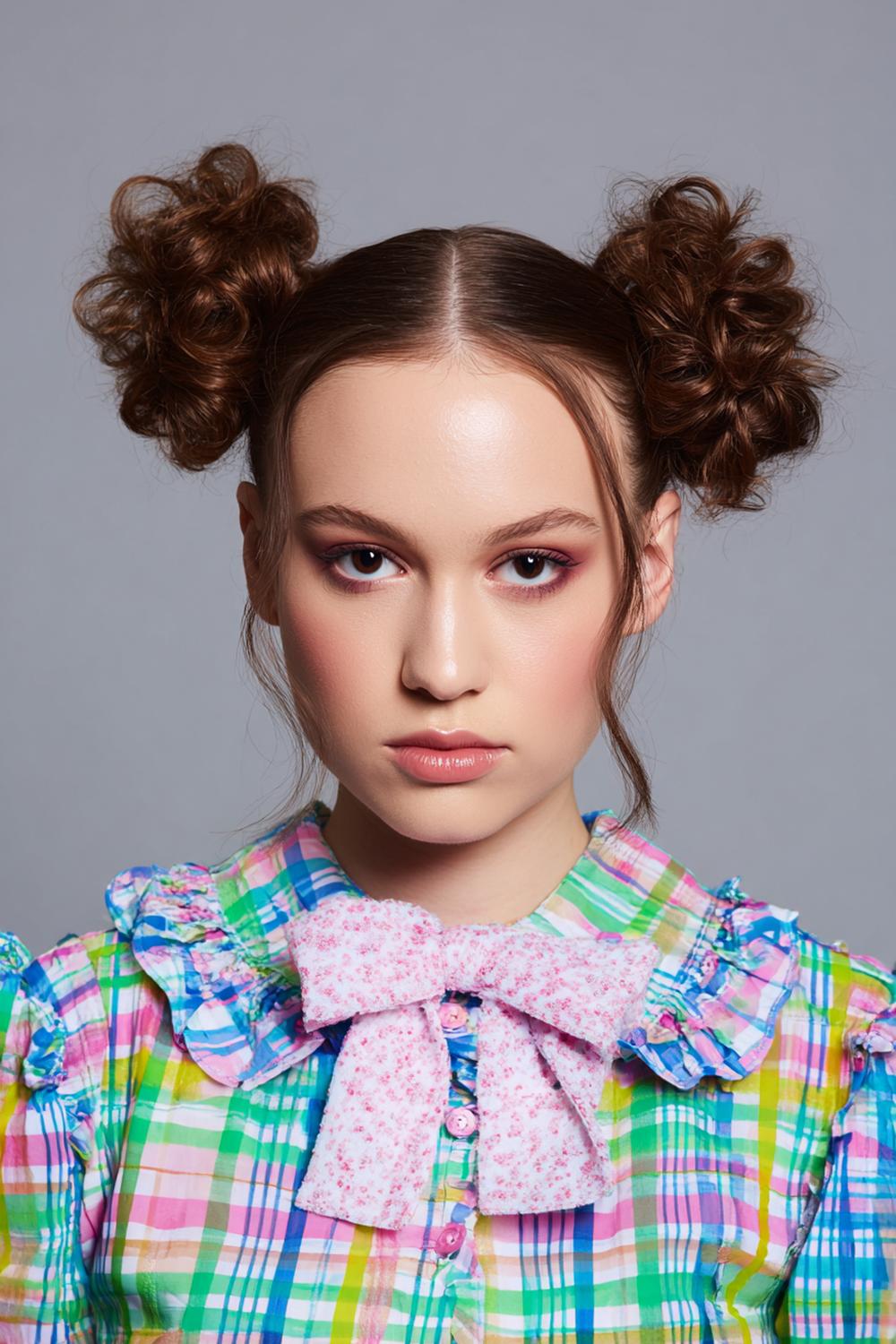 18. Space Buns Hairstyle with Center Part and Playful Symmetry