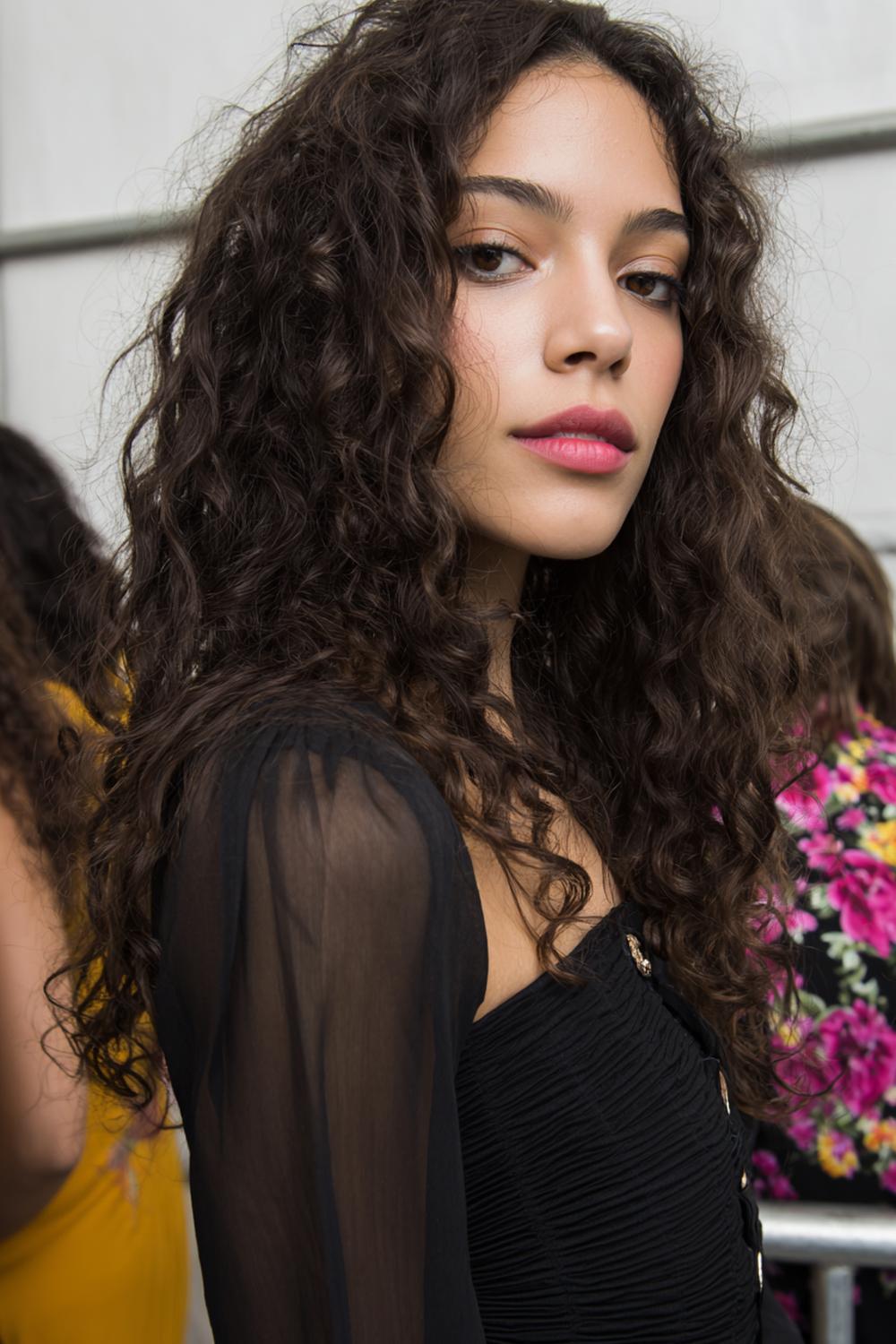 27. Hairstyles for All Hair Types: Loose Spiral Curls with Center Part and Volume
