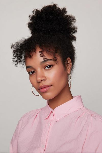 21. Twisted Crown Updo with Soft Volume for hairstyles for curly hair updo ideas