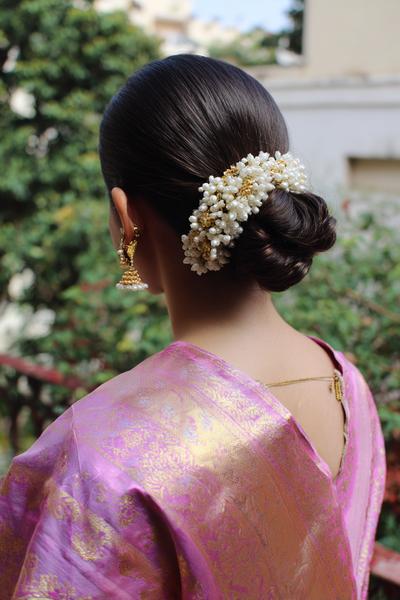 19. Jasmine-Inspired Low Bun with Gajra Accent for hairstyles for long hair on saree ideas