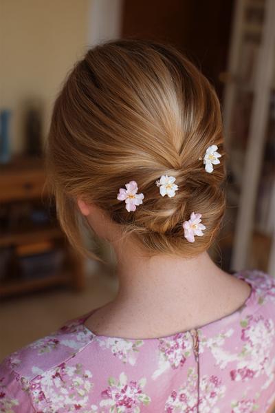 24. Twisted Low Updo with Floral Pins for hairstyles for medium length hair updo ideas