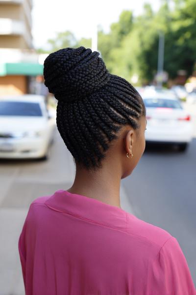 18. Knotless Braided Low Bun with a Clean Middle Part for hairstyles for school braids black women ideas