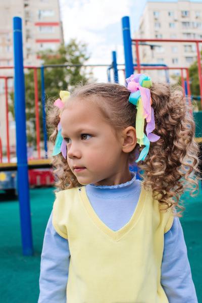 13. Playground-Proof Double Ponytails for Hairstyles for School Curly Hair Kids with Colorful Elastics