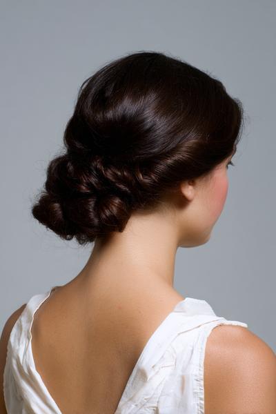 26. Low Chignon Bun for Hairstyles for School Curly Hair Bun with a Twisted Nape and Shine