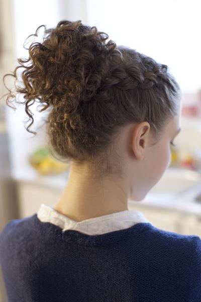 28. Braided Base Bun for Hairstyles for School Curly Hair Bun with a Single Accent Plait
