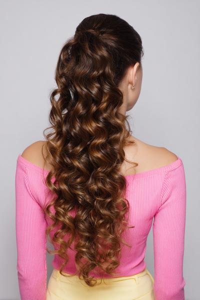 29. Long Curly Ponytail for Hairstyles for School Curly Hair Long with a Sleek Root and Full Ends
