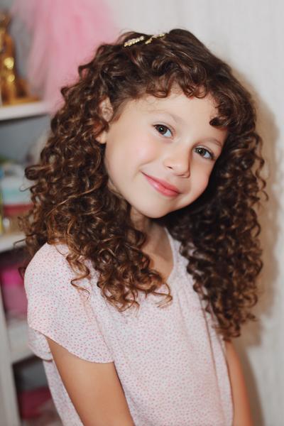 22. Defined Curly Bang Styling With Mini Side Clips for hairstyles for school down curly ideas