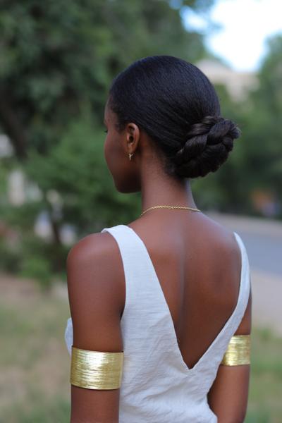 10. Low Twisted Bun for Hairstyles for School Natural Hair with Gold Cuffs