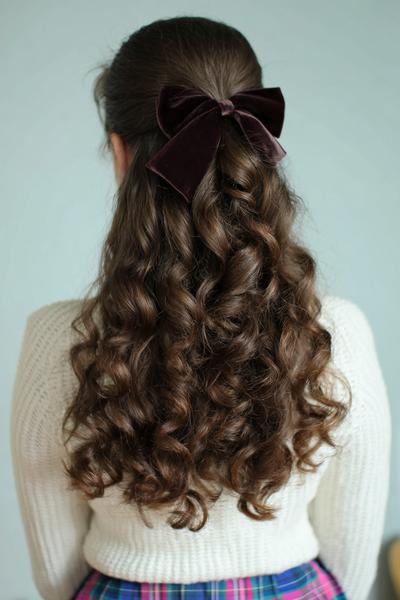 14. Half-Up Curly Bow Ponytail for Hairstyles for School Curly Hair with Volume