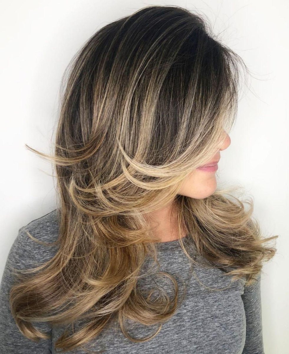 Layered blowout with side swept bangs
