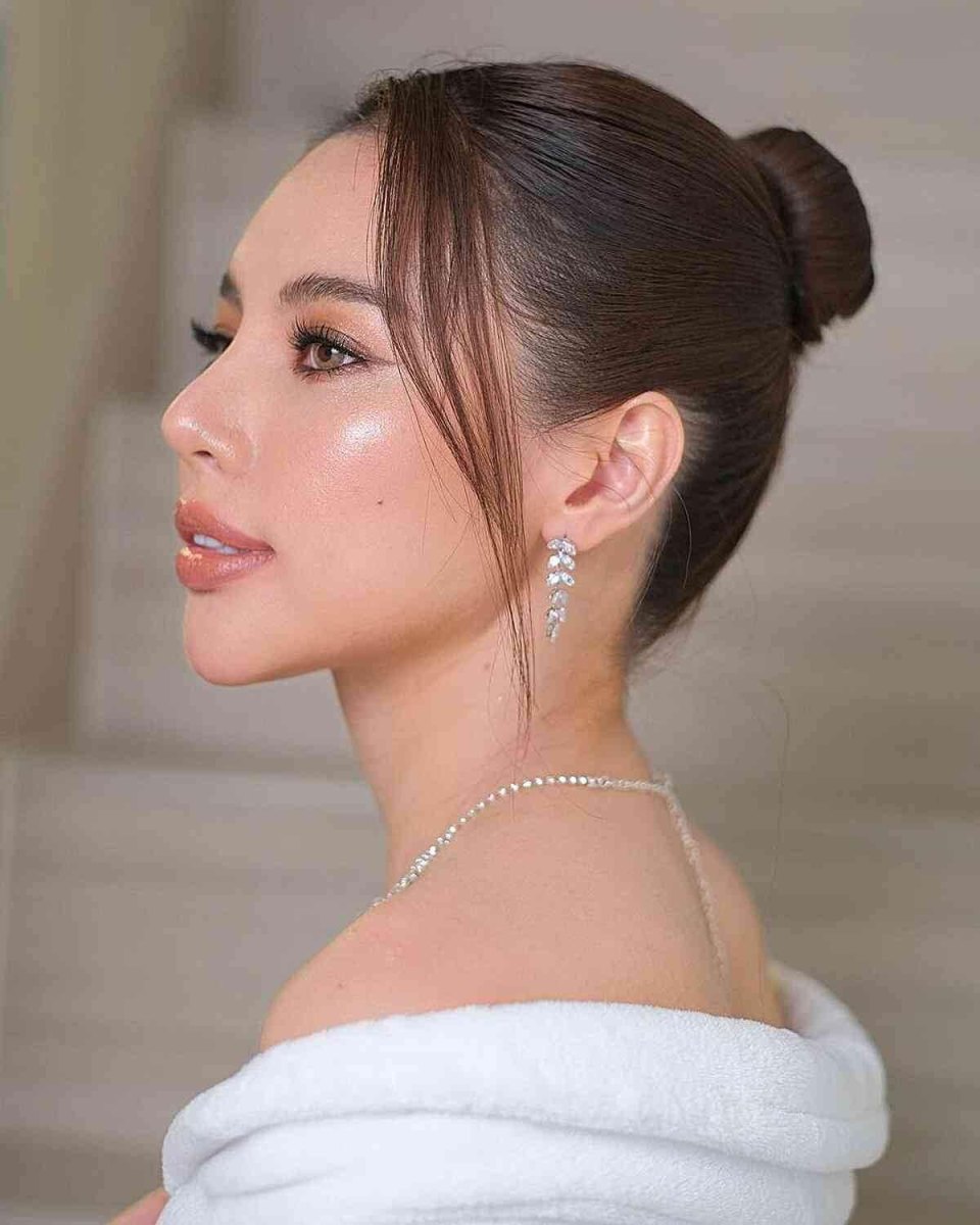 Sleek updo with long face framing strands