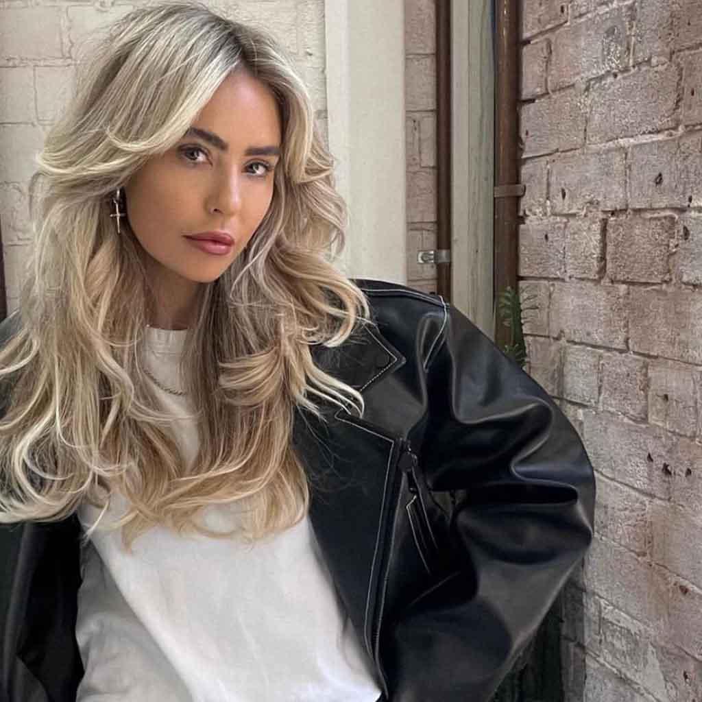 Bright blonde curtain layers in 90s blowout style