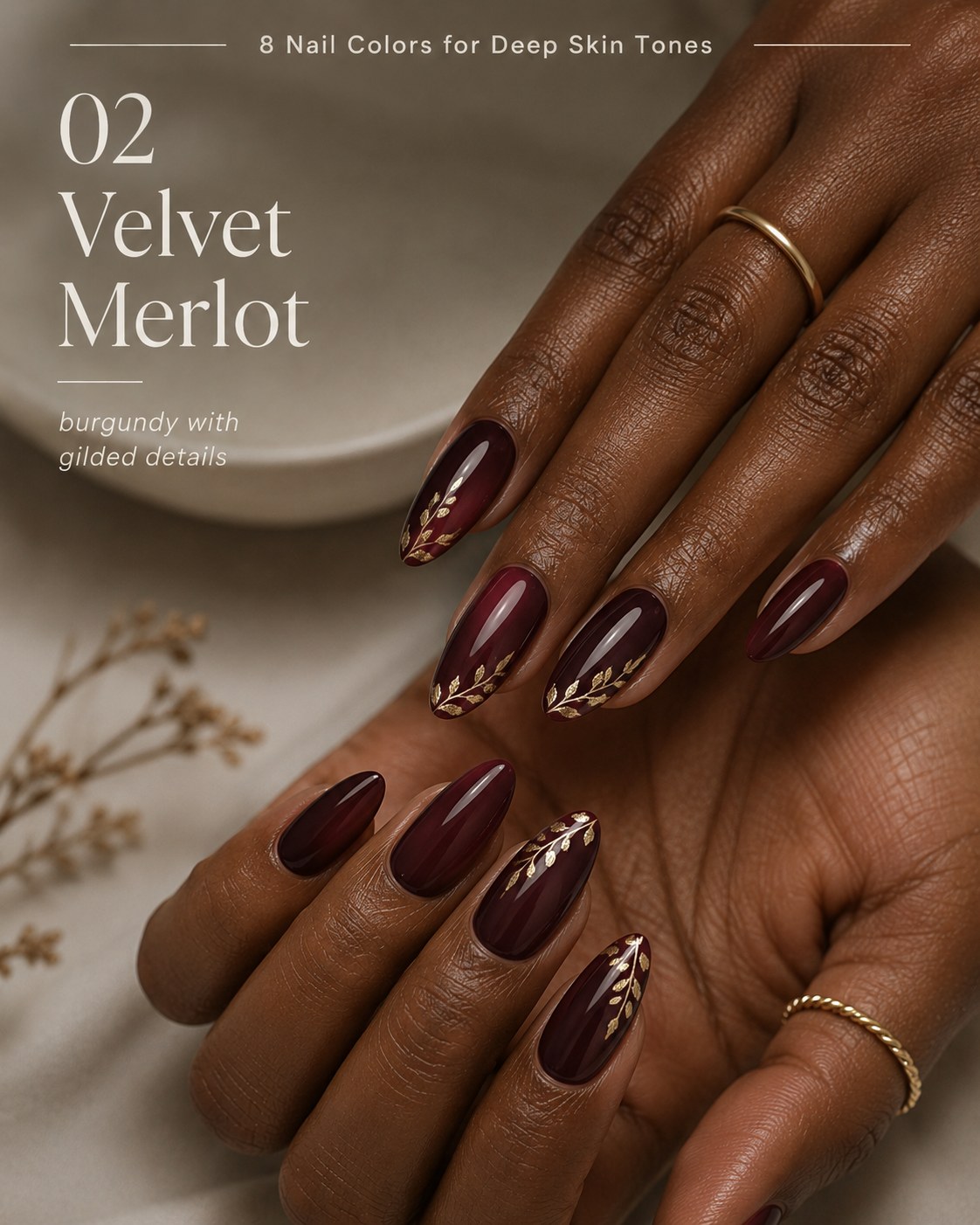 Burgundy nail color for deep skin tones finished with gilded leaf nail art details