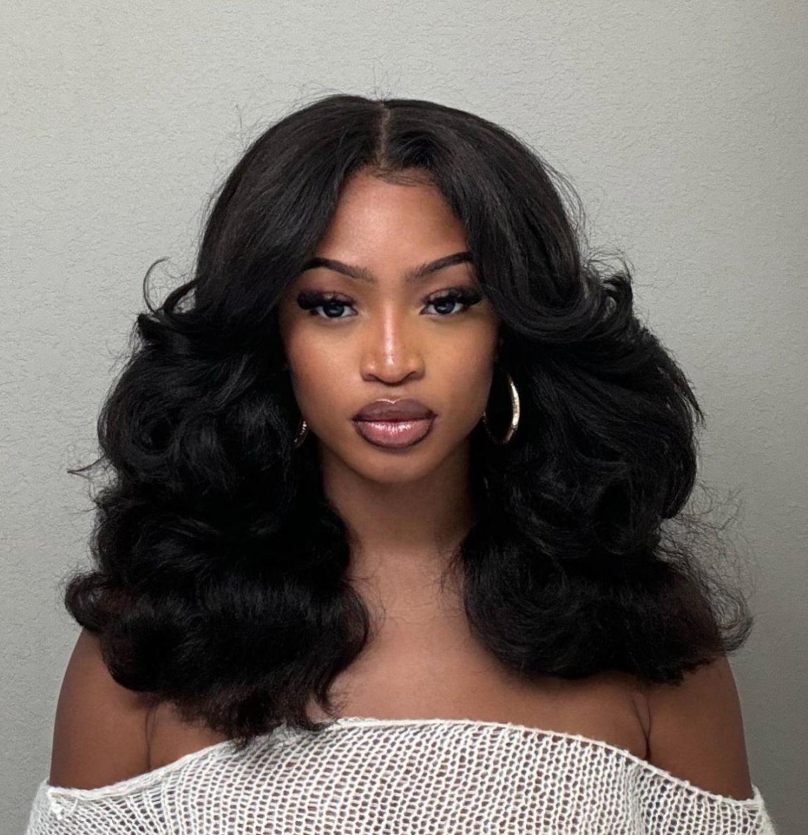 Chestnut hair styled with rounded 90s blowout layers