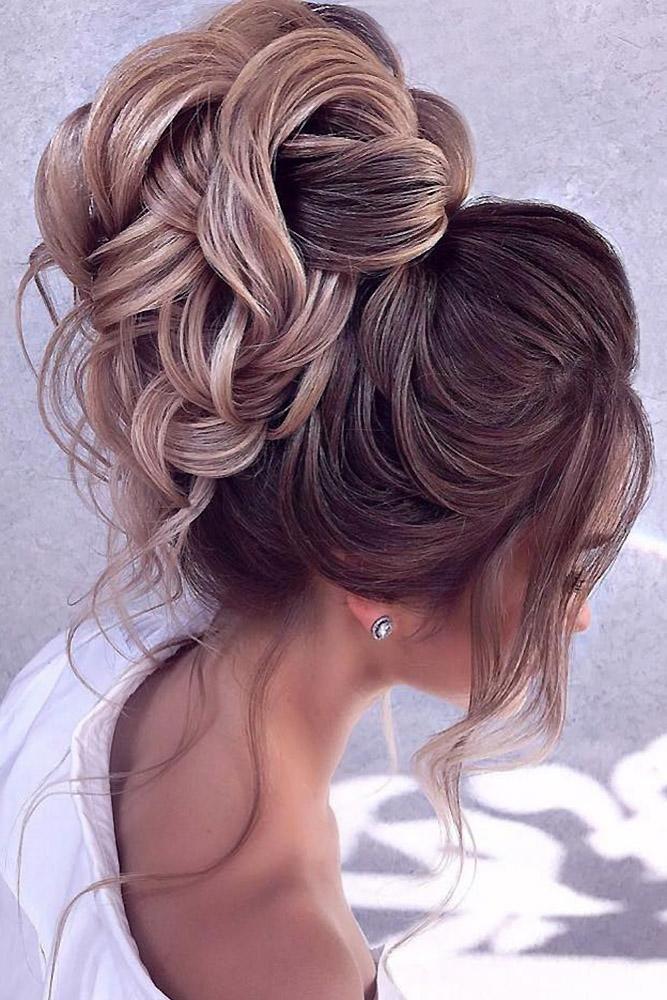 Curled statement messy high bun updo style