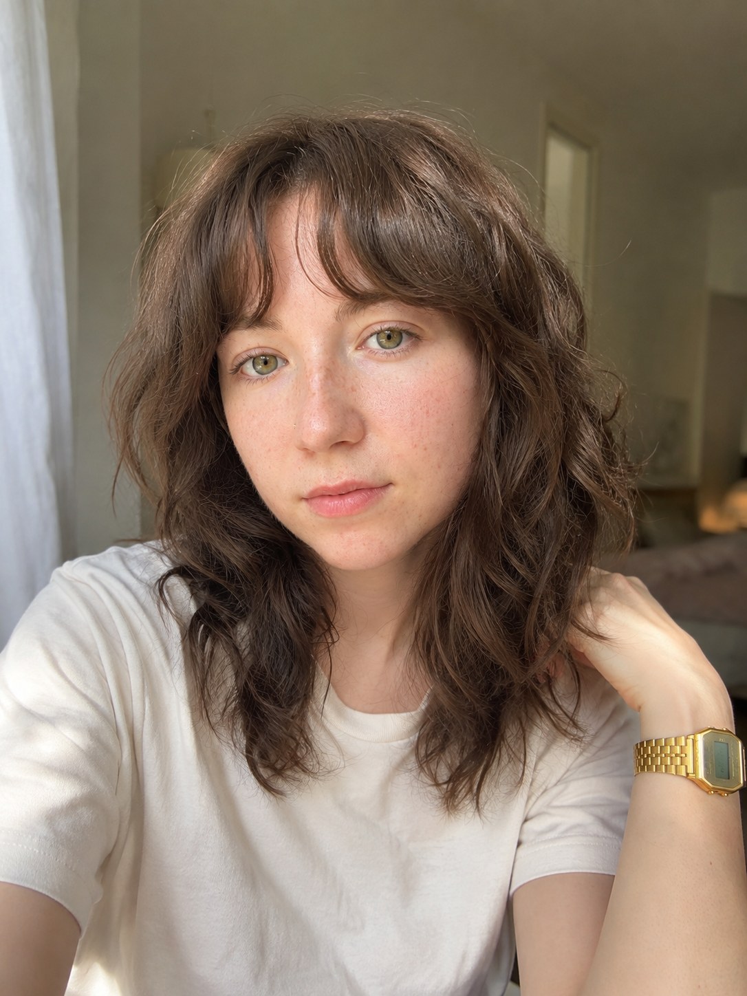 Soft wavy brunette shag haircut with a light fringe showing natural texture