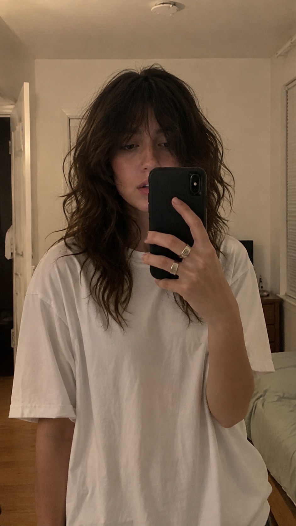 Brunette wolf shag haircut with tousled, voluminous crown layers and undone texture