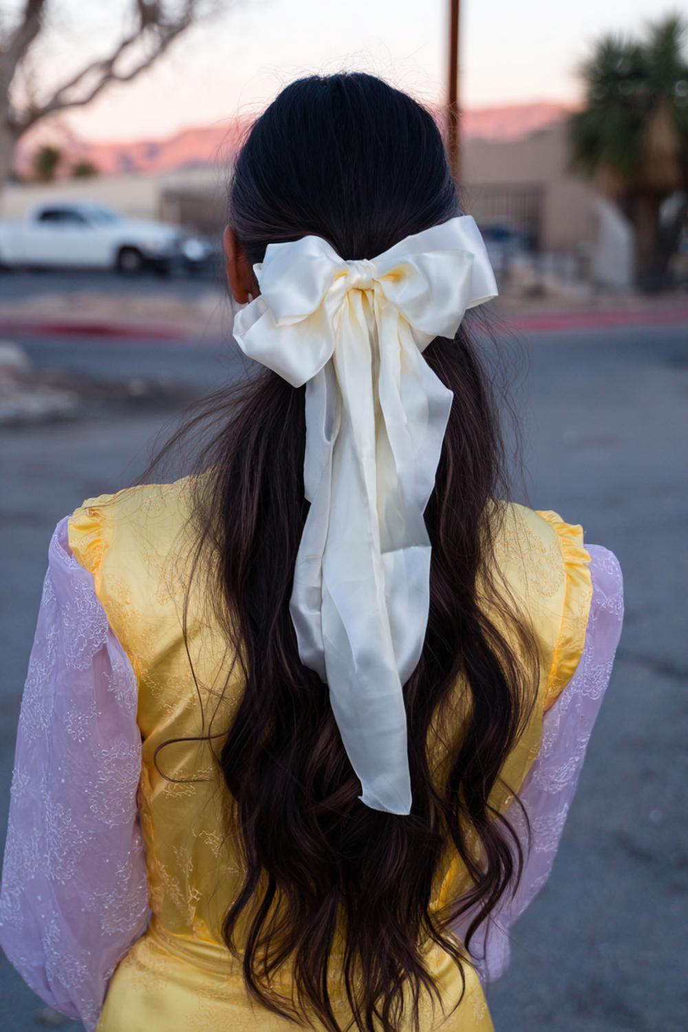 16. Ribbon Ponytail Hair with Bow Detail and Loose Waves