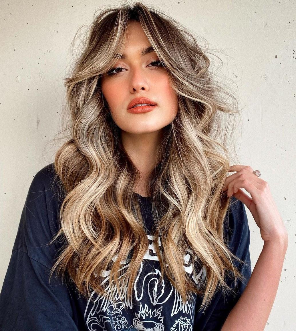Wavy long layers curtain bangs hairstyle
